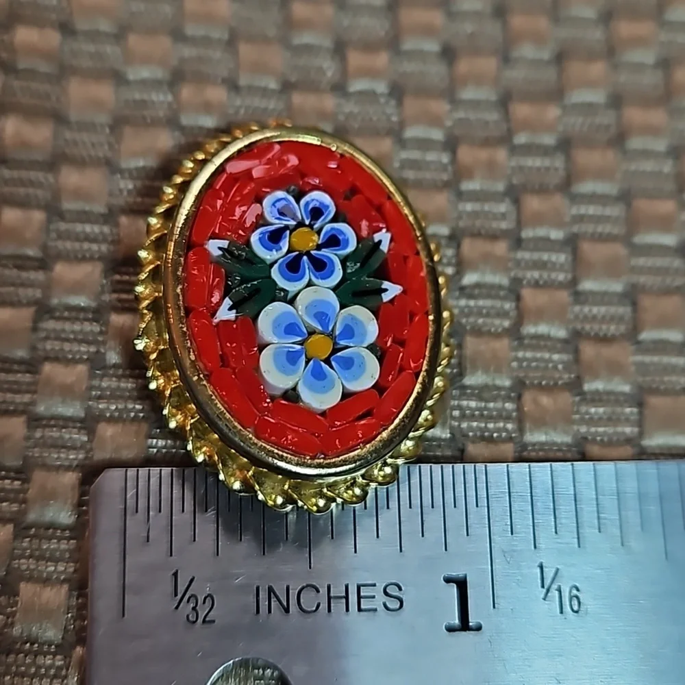Vintage millefiori micro mosaic flowers pin brooch set in a gold edged frame.